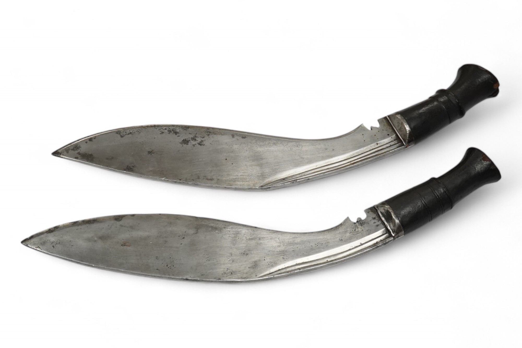 Two military kukri; one with blade stamped with British government ownership mark and issue date February 1916, with wooden handle, no scabbard and another almost identical with board of ordnance mark issued March 1917.